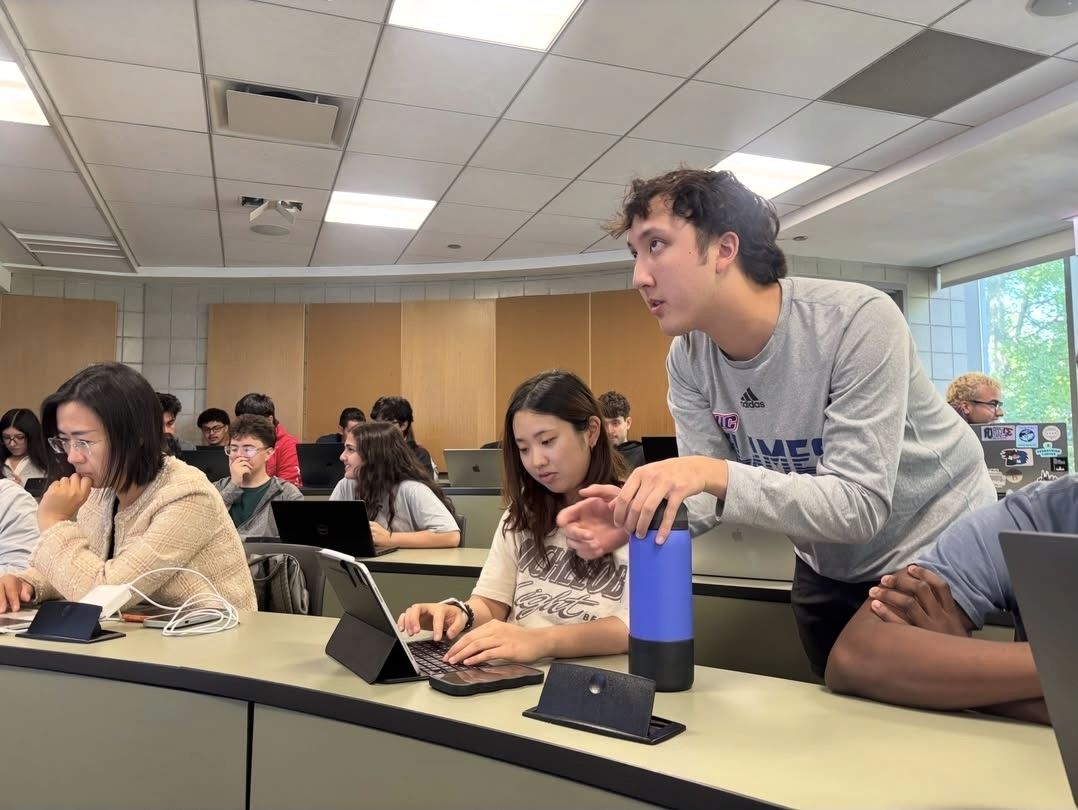 An Excel Club lead helping a member with a spreadsheet on her laptop