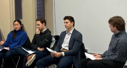 Four professionals seated in a row answering questions at a FIG panel