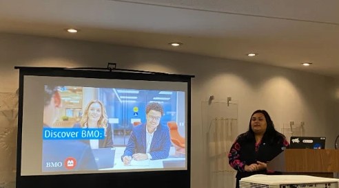 A recruiter from BMO presenting to FIG members, with a Discover BMO slide on the screen